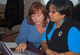 Two women use the @YourSide program at a computer
