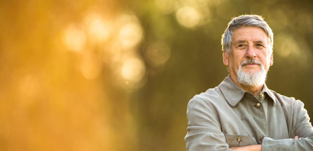 middle-aged man standing outside, staring into the distance