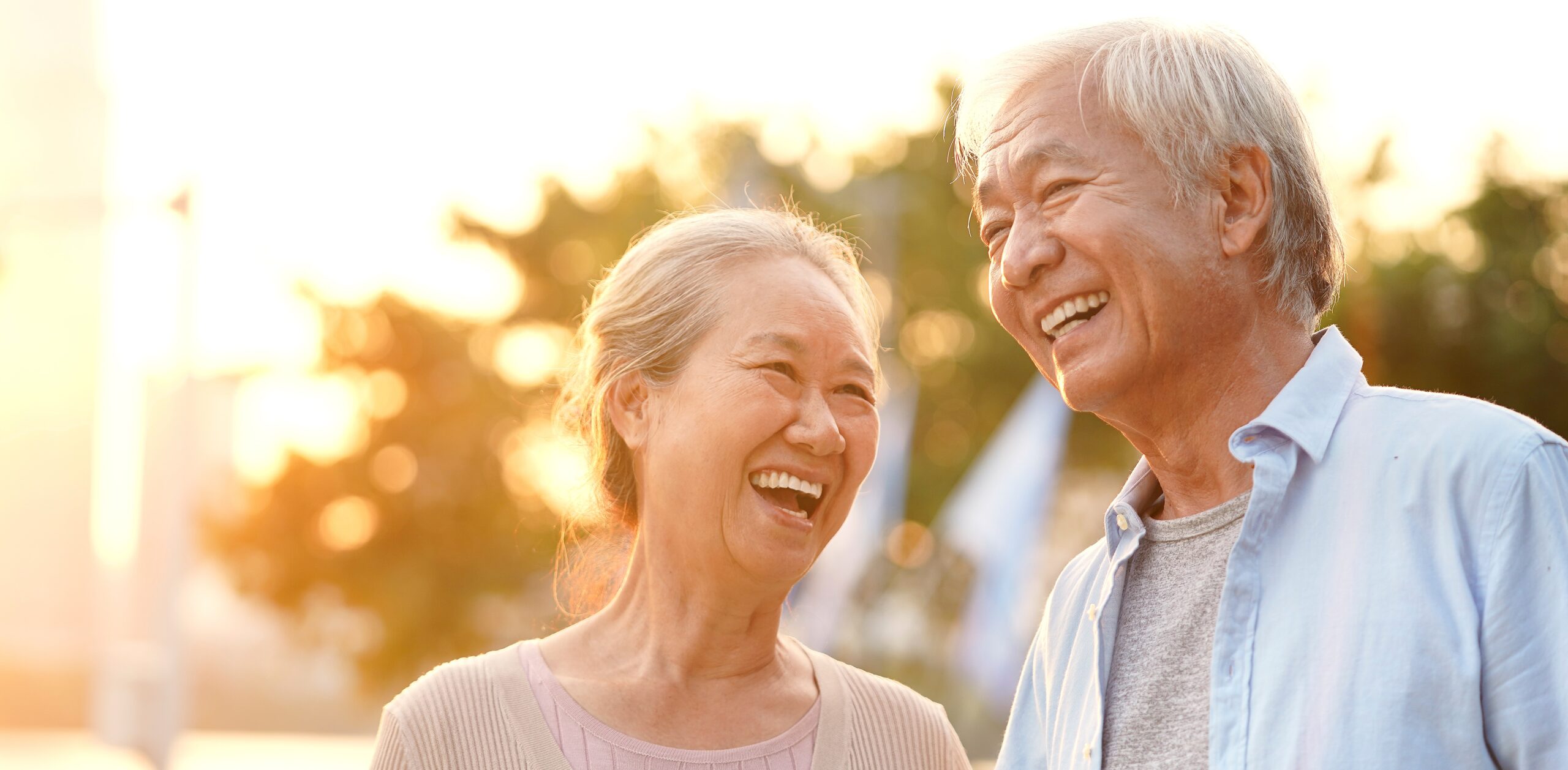 older couple smiling outdoors
