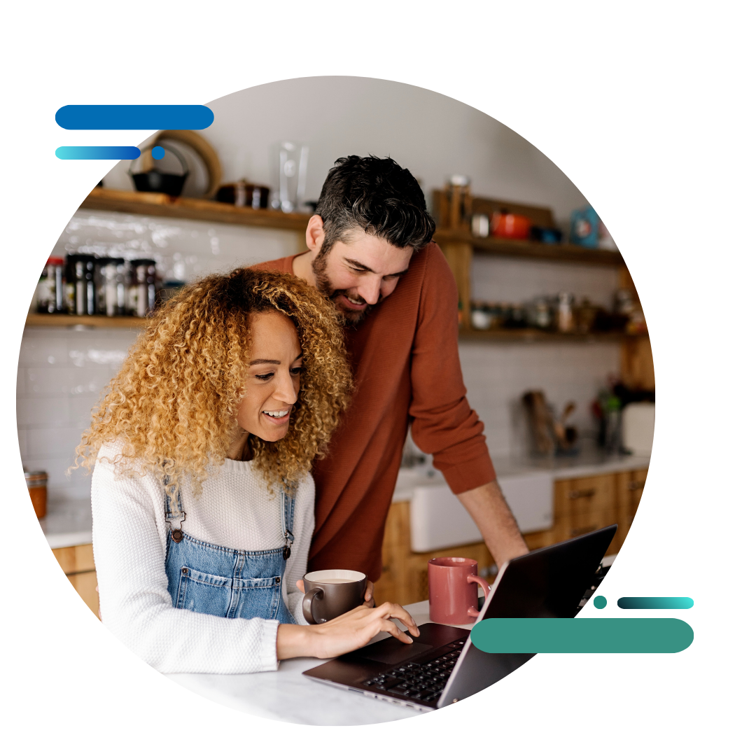 couple in kitchen looking at laptop
