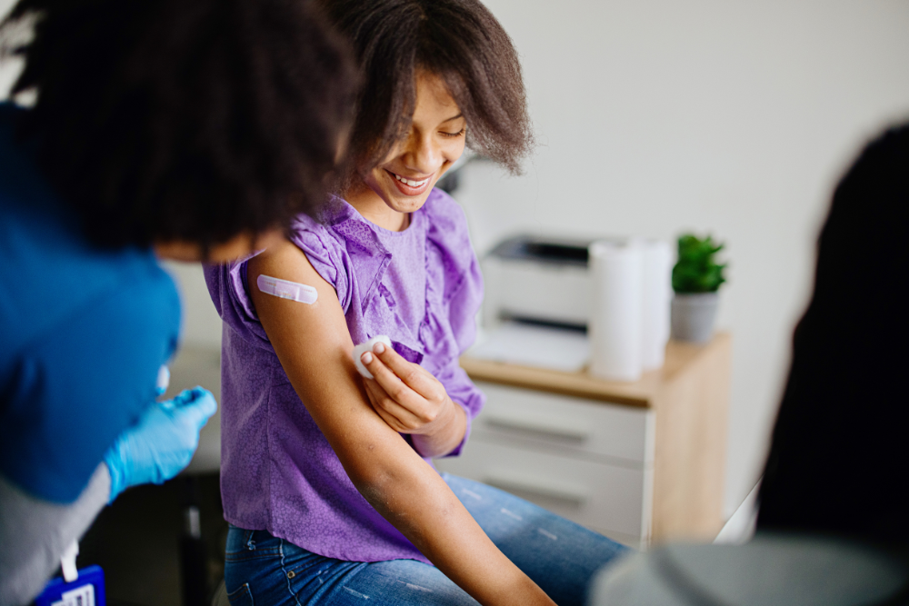 teen getting band aid after vaccination