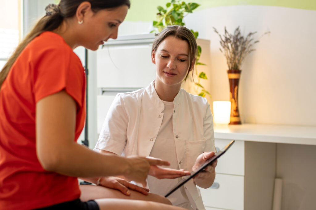 Patient and an assistant review medical details on a clipboard together