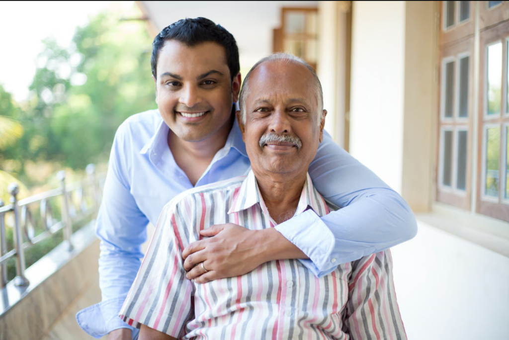 two adults posing together on a porch