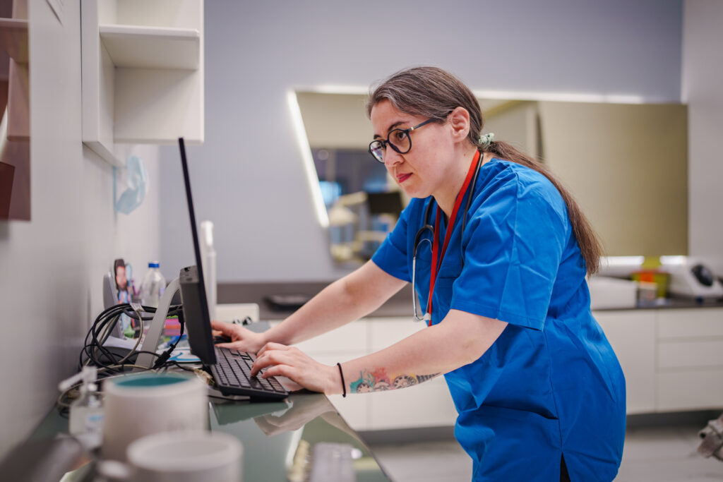 healthcare worker entering data